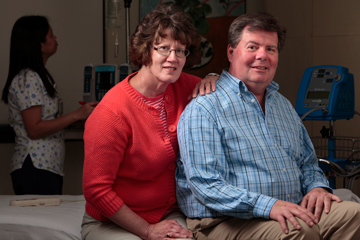 Husband and Wife sitting on the edge of a hospital bed