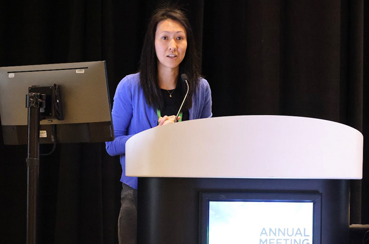 Hwang pictured at podium at AACR annual meeting