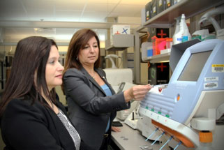 A woman demos the equipment to another woman